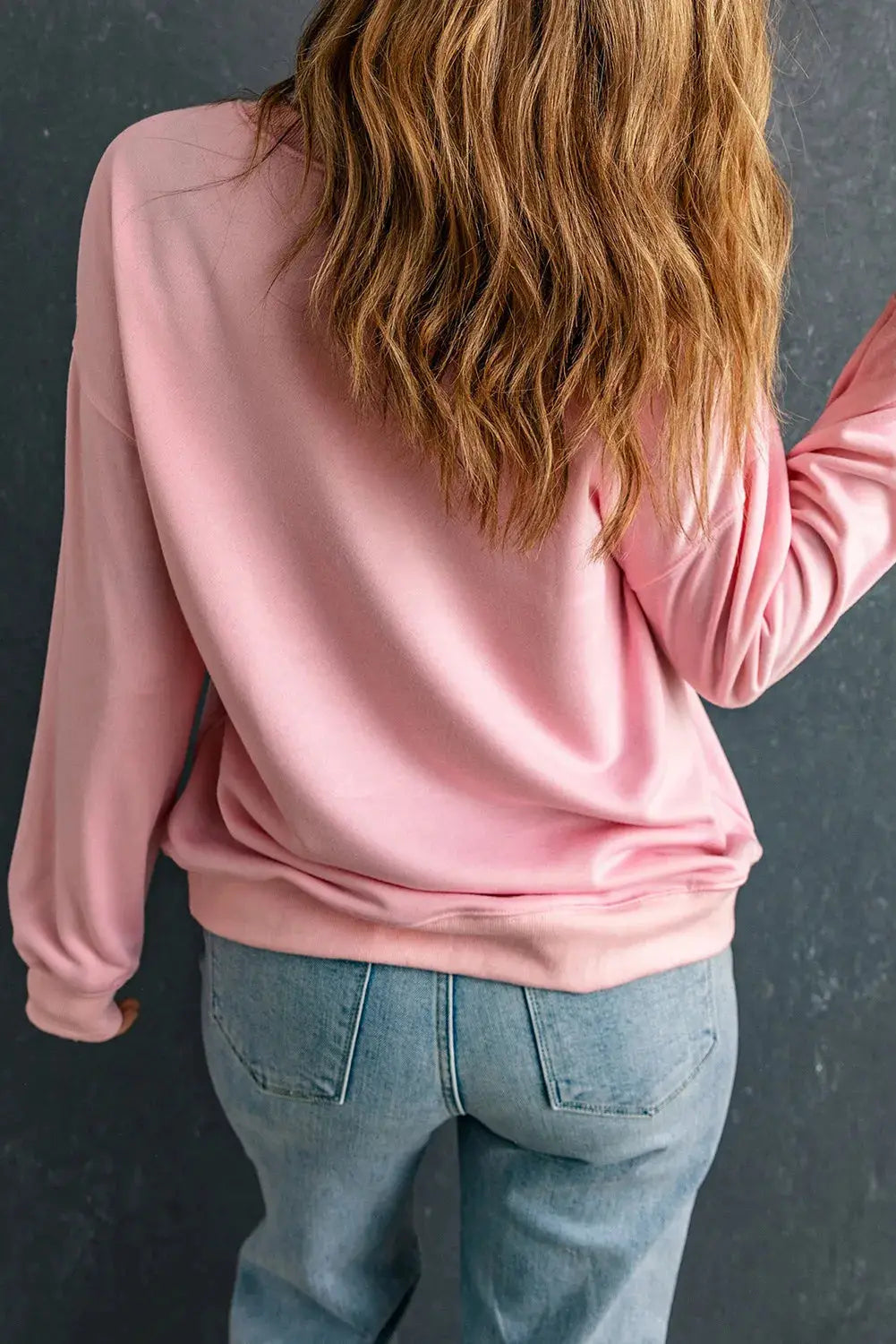 Back view of pink long sleeve sweatshirt, casual style.