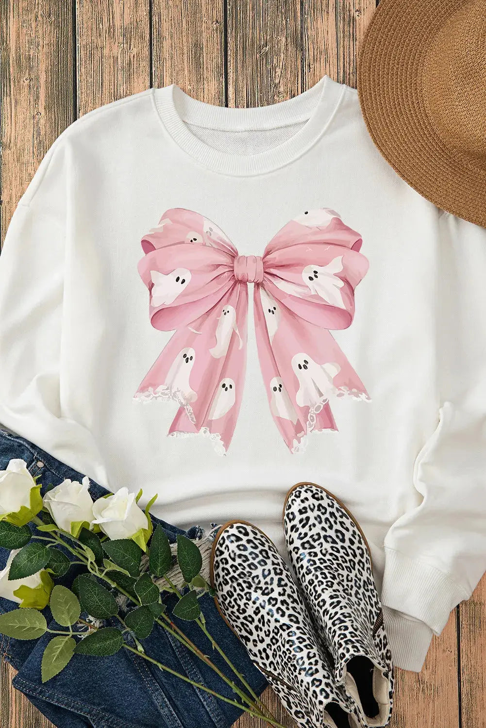 Sweatshirt with pink bow and ghost print, styled with accessories