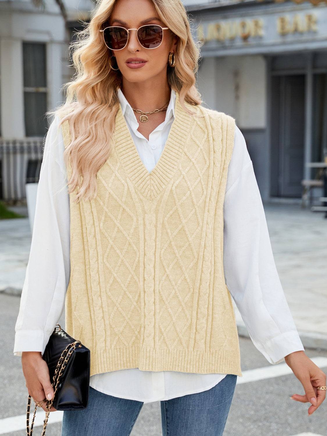 Beige cable knit V-neck sweater vest with sunglasses