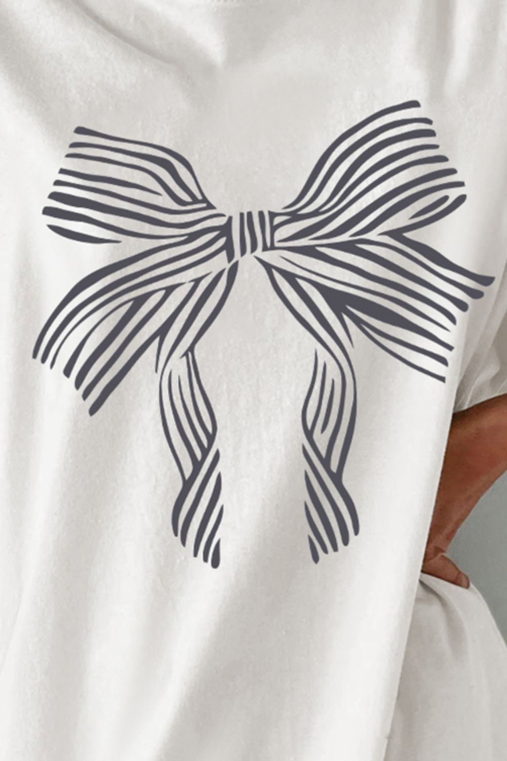 Close-up of bow graphic on white T-shirt