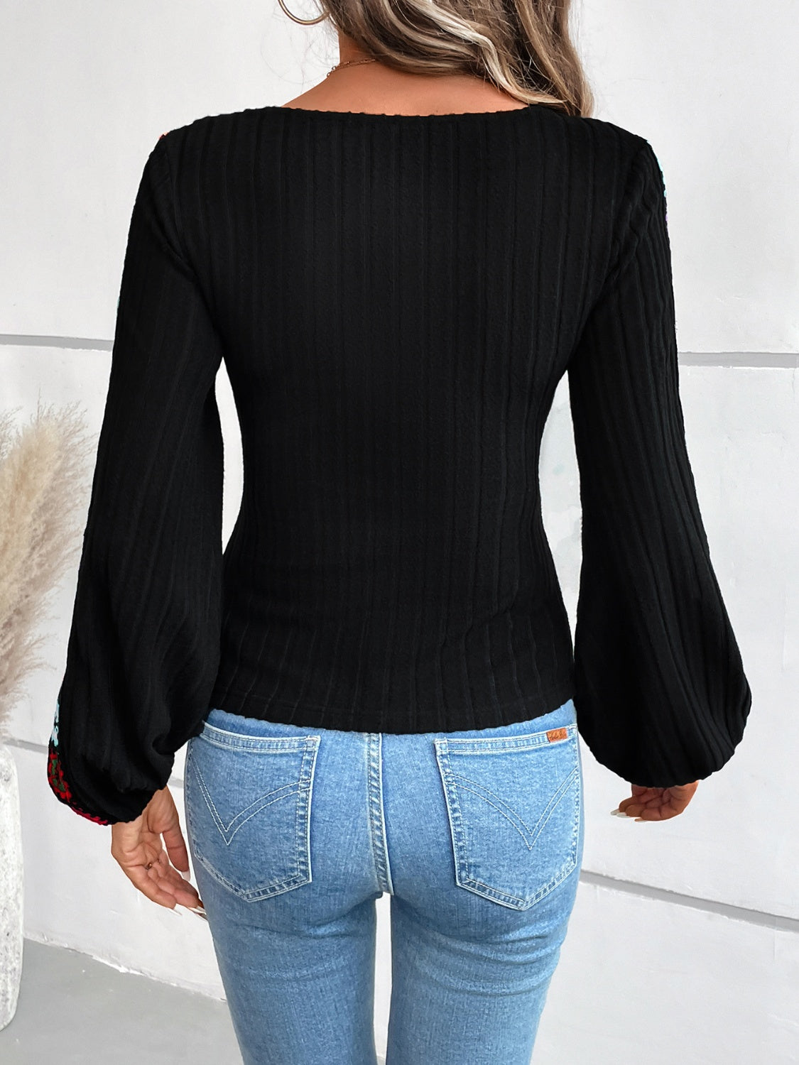 Back view of black V-neck crochet long sleeve top