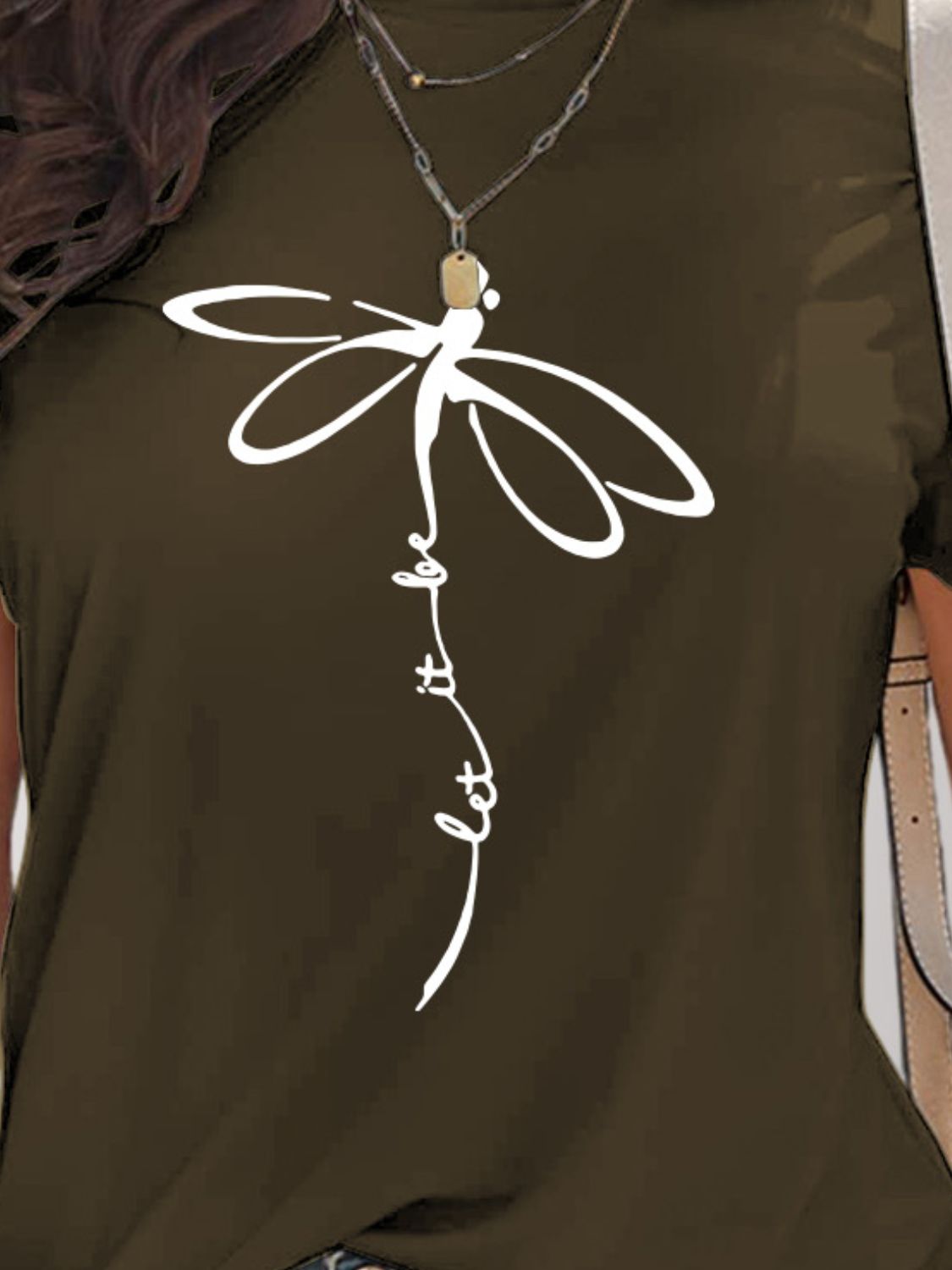 Close-up of dragonfly graphic on dark olive t-shirt
