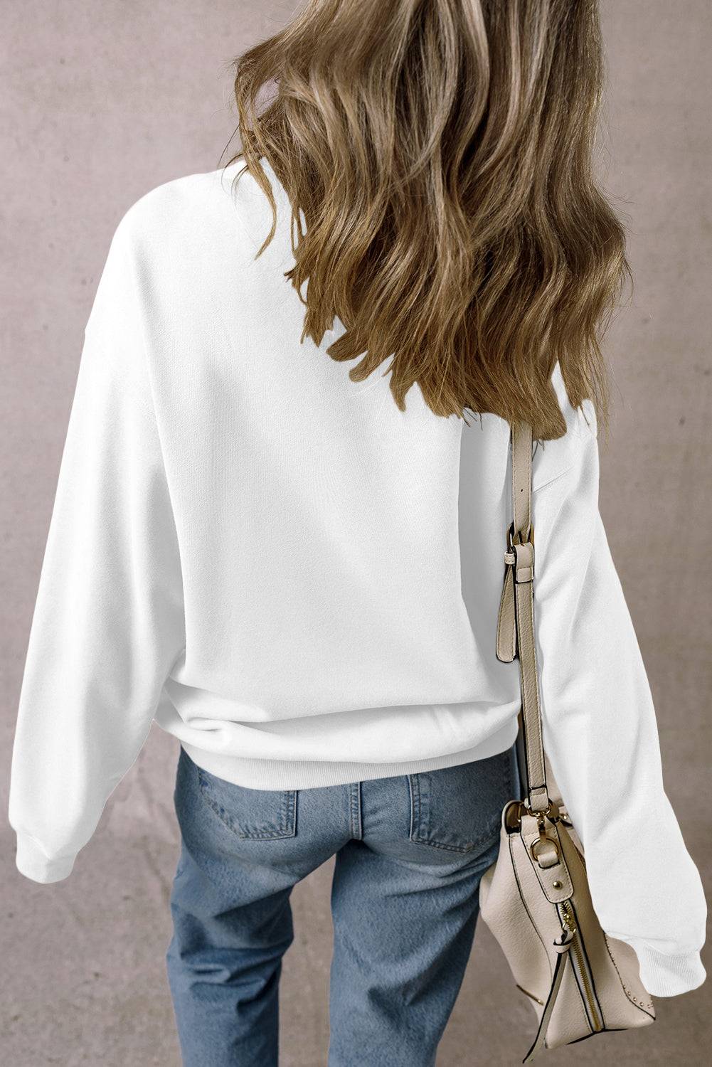 Back view of white TEXAS sweatshirt with dropped shoulders.