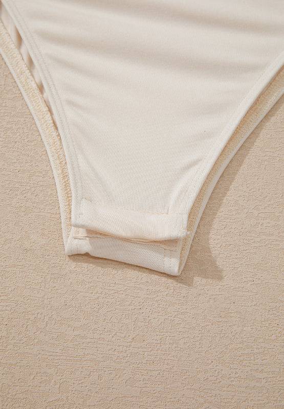 Bottom detail of sequin surplice bodysuit