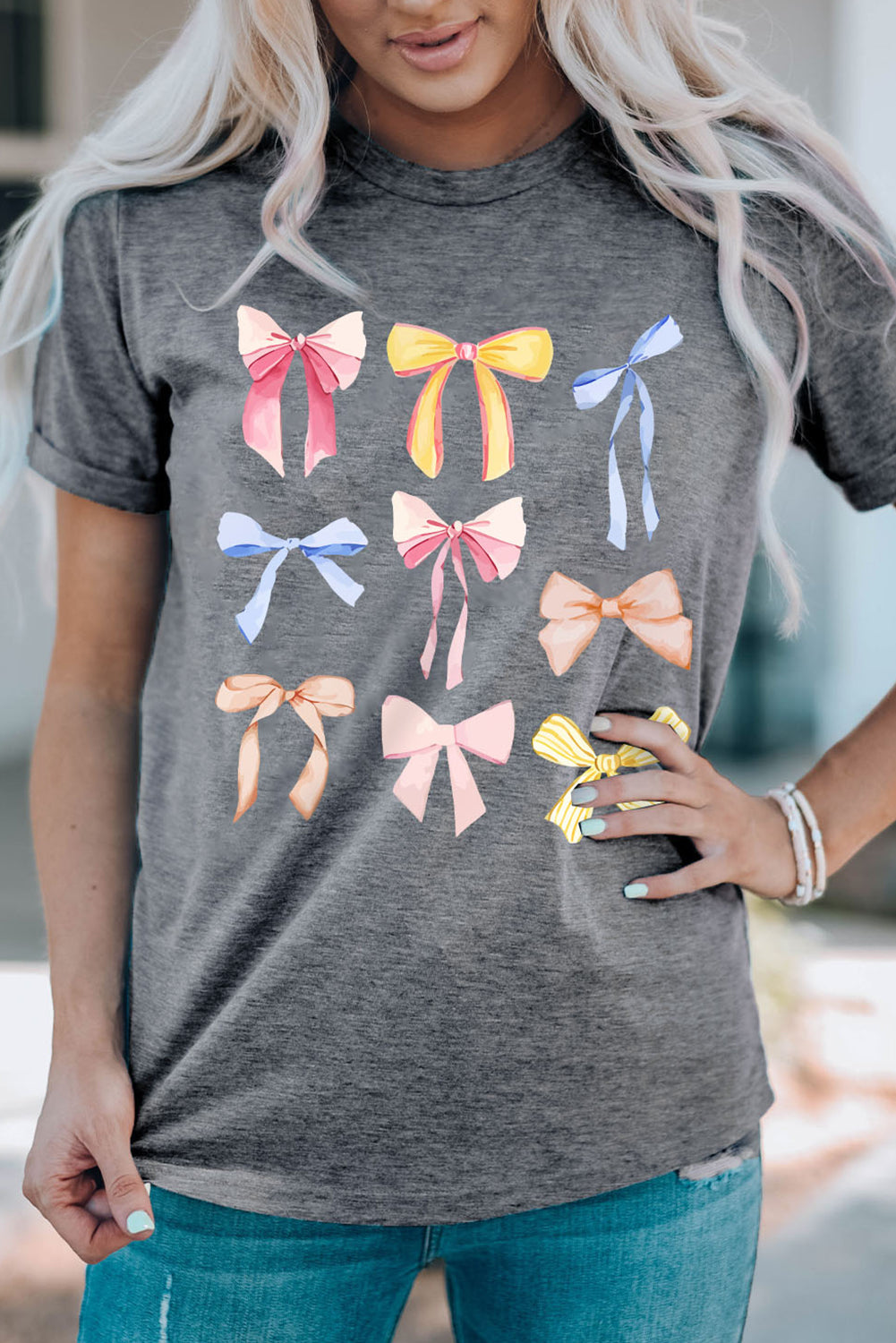 Dark gray T-shirt featuring vibrant bow graphics, front view