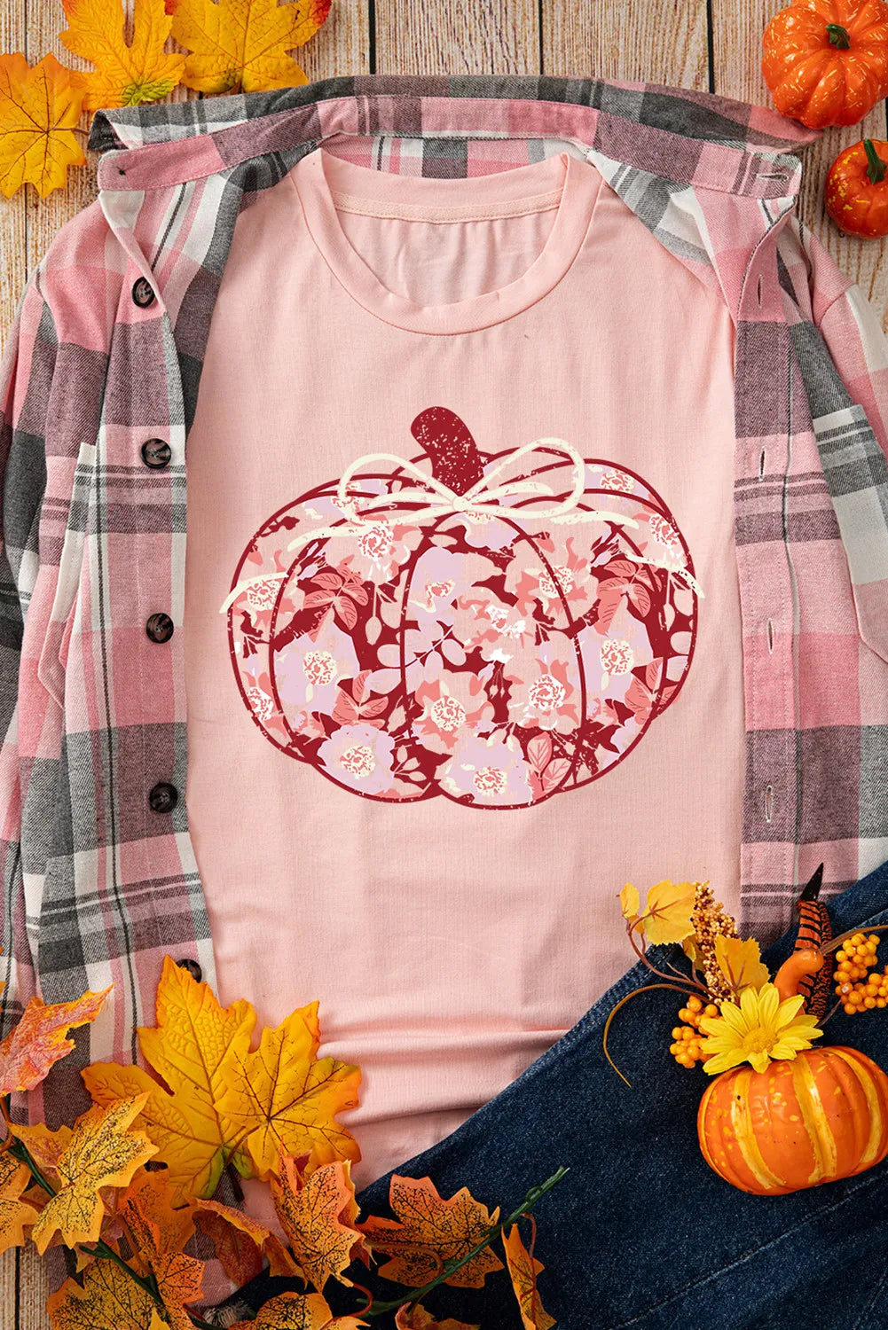 Pumpkin graphic t-shirt styled with plaid shirt and autumn decor
