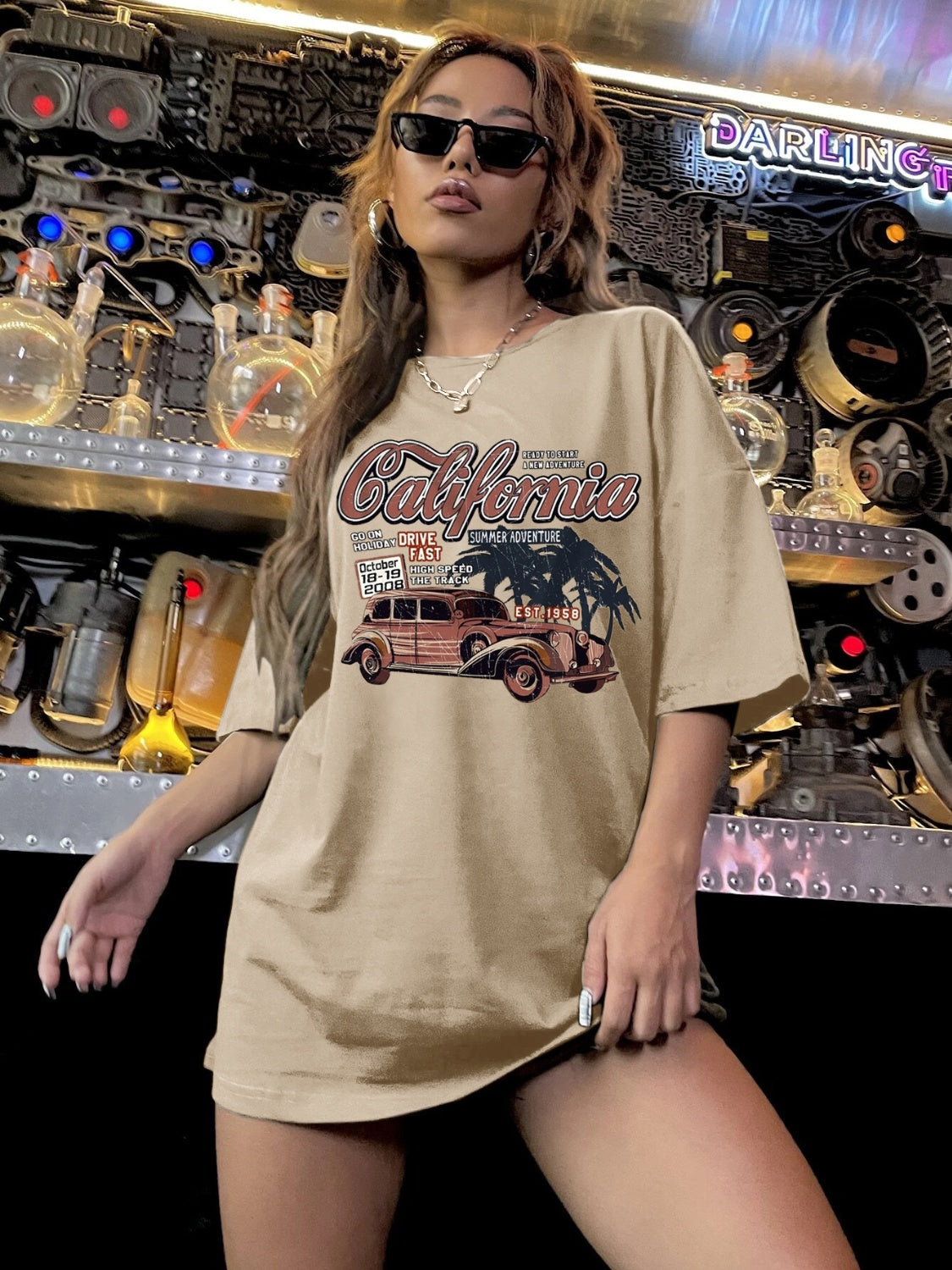 Model wearing car graphic t-shirt, industrial background