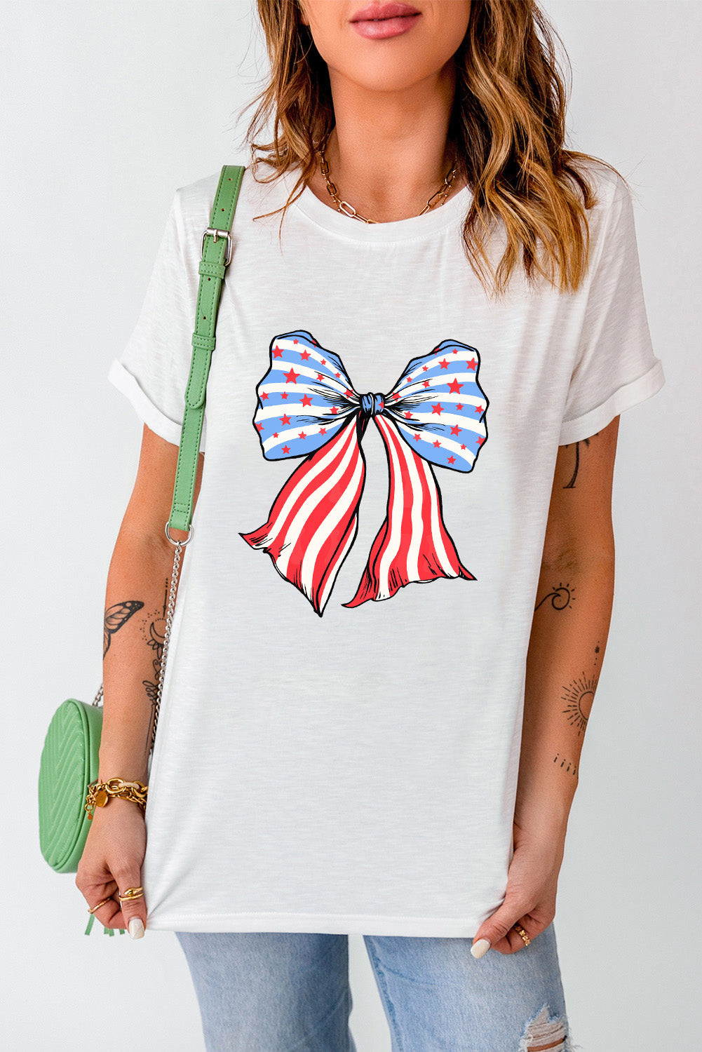 Round neck T-shirt featuring bow graphic, short sleeves.