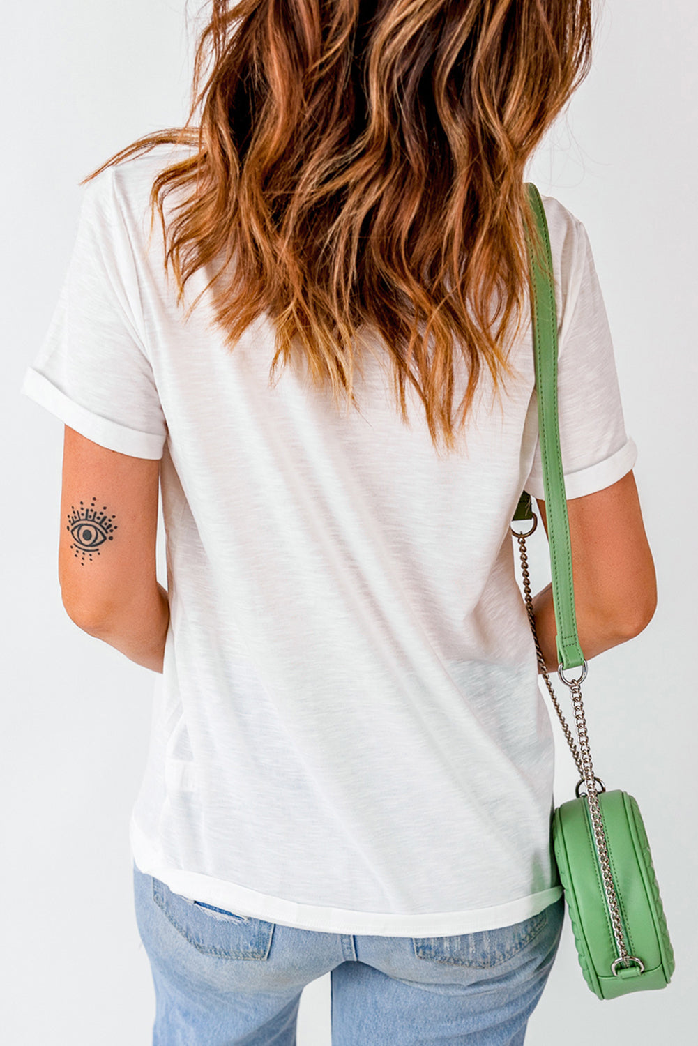 Back view of white T-shirt with rolled sleeves.