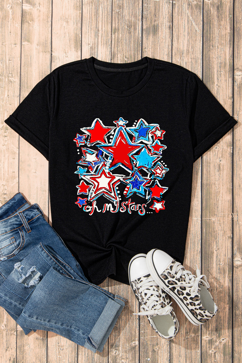 Graphic t-shirt with star design paired with jeans and sneakers