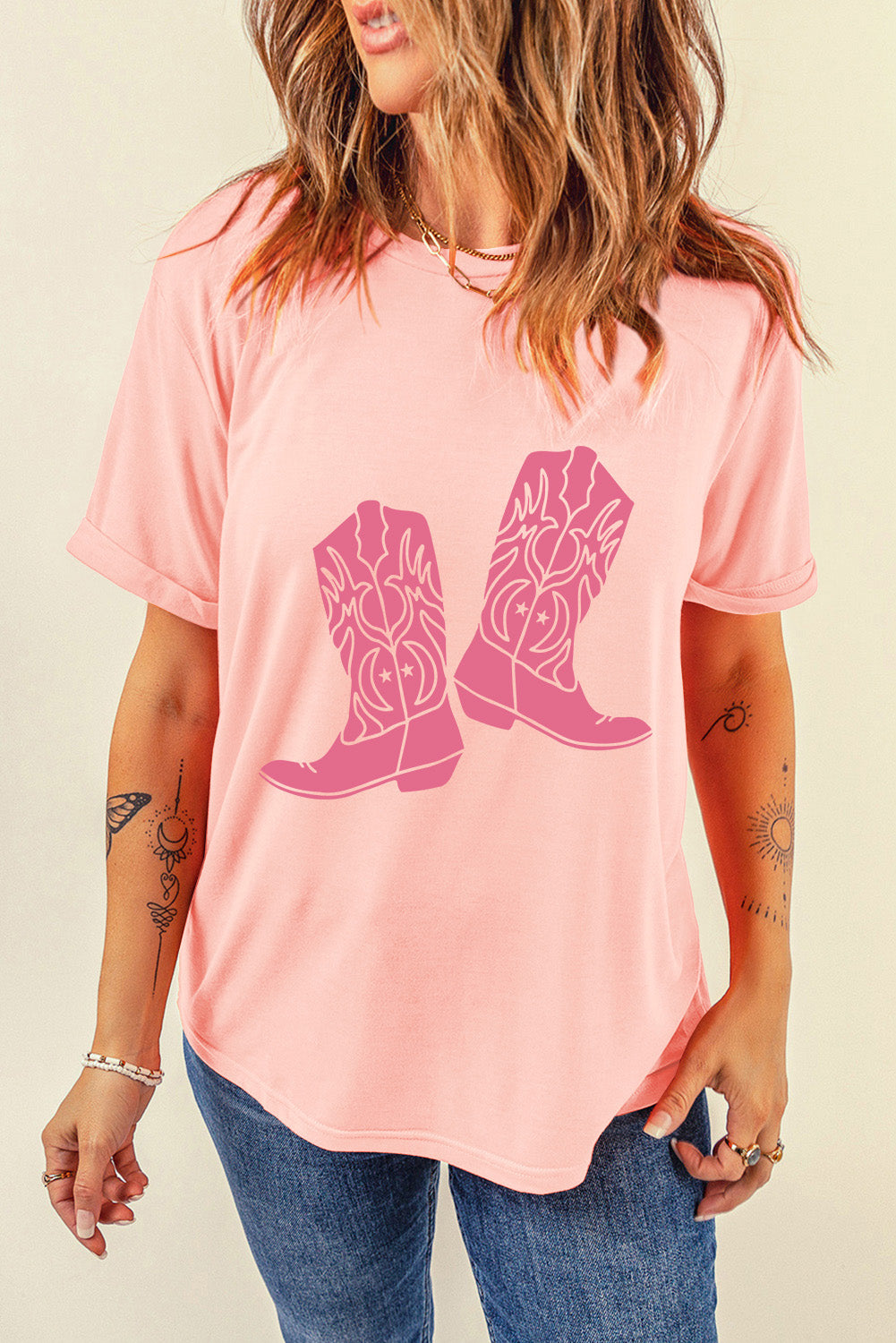 Pink T-shirt featuring boots graphic, round neck, short sleeves
