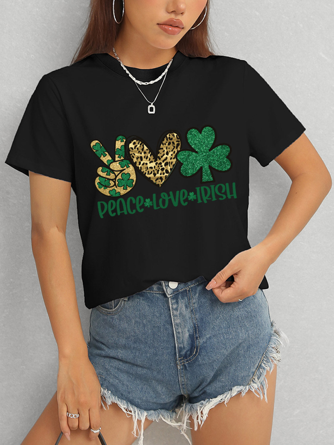 Model in black Peace Love Irish T-Shirt and denim shorts
