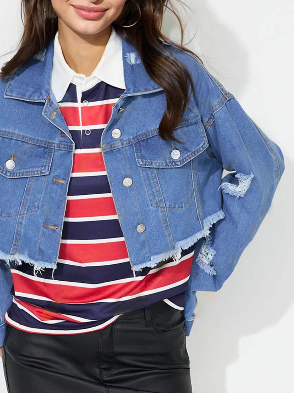 Close-up of raw hem denim top with collared neck.