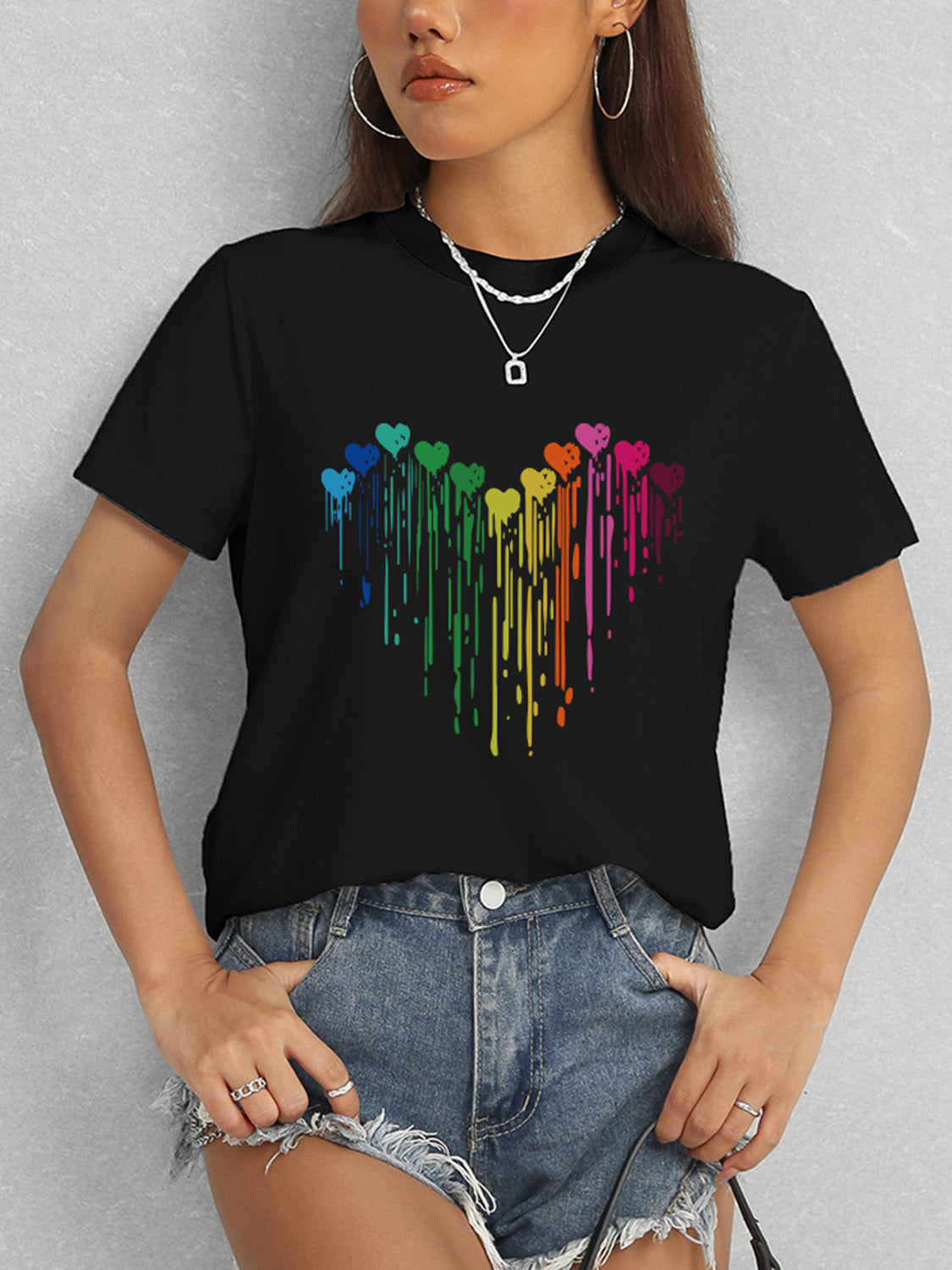 Black short sleeve t-shirt featuring colorful heart pattern