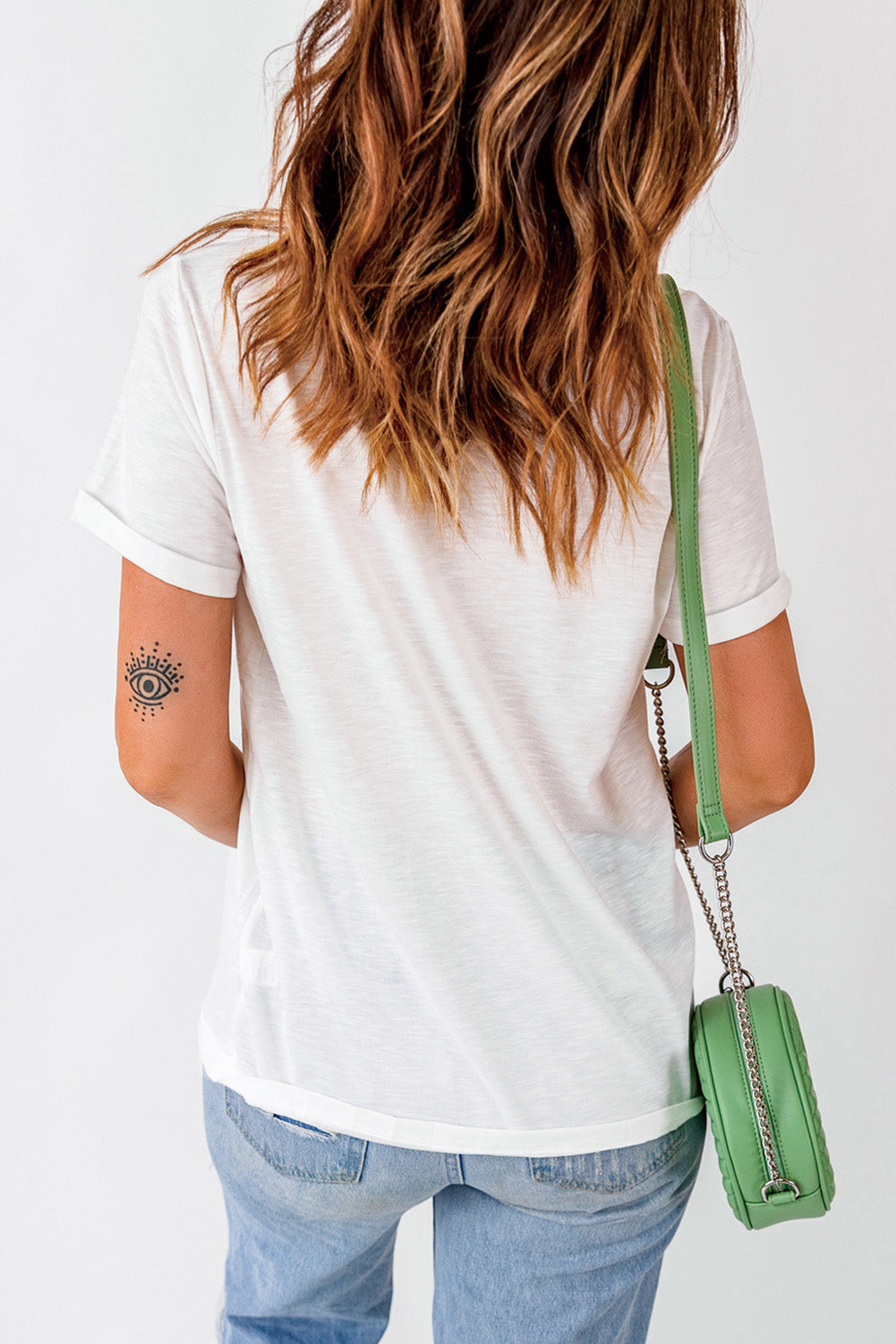 Back view of white T-shirt, simple design with rolled sleeves.