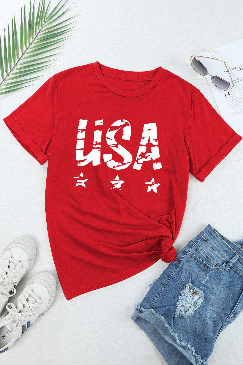 Flat lay of red USA t-shirt with jeans and sneakers