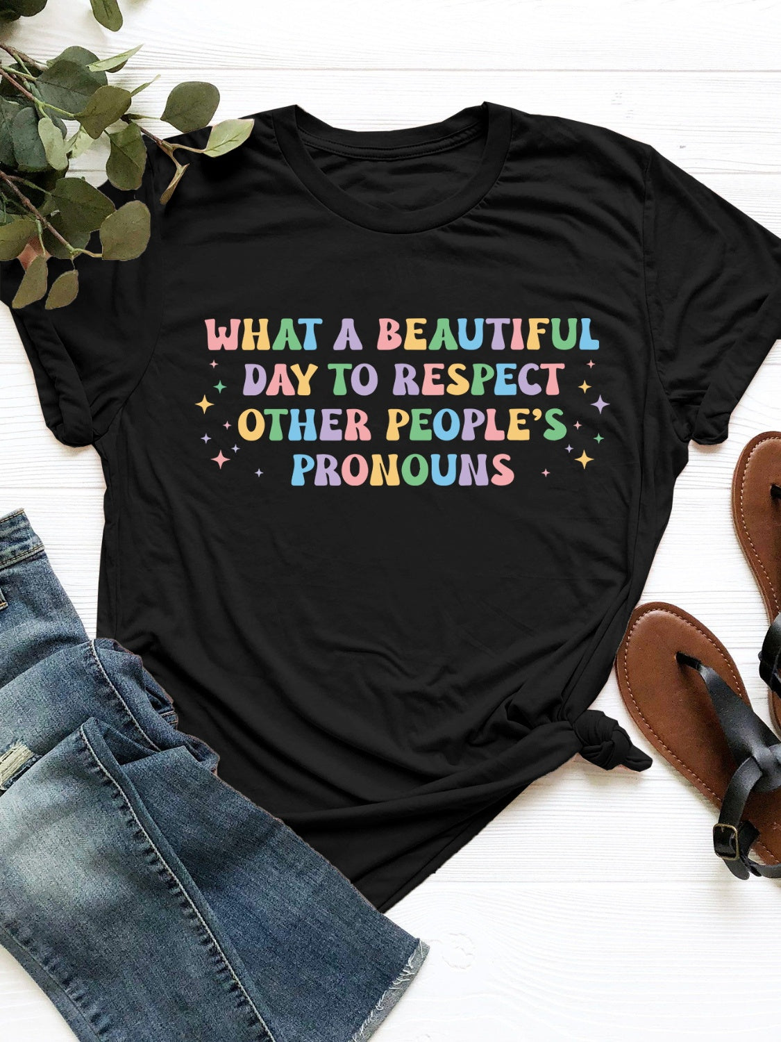 Black T-shirt with colorful pronoun respect message