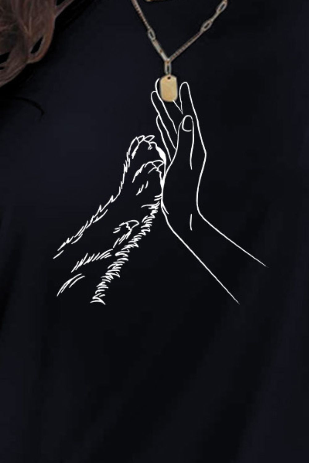 Close-up of hand and paw graphic on T-shirt