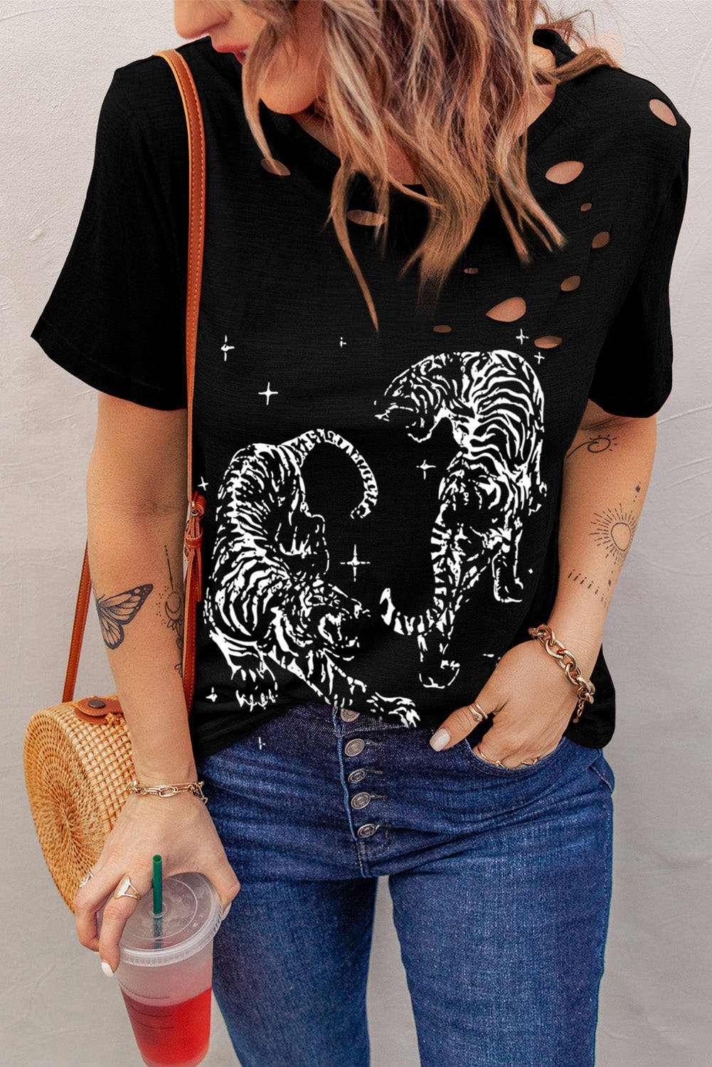 Stylish black T-shirt with cutout design and graphic print