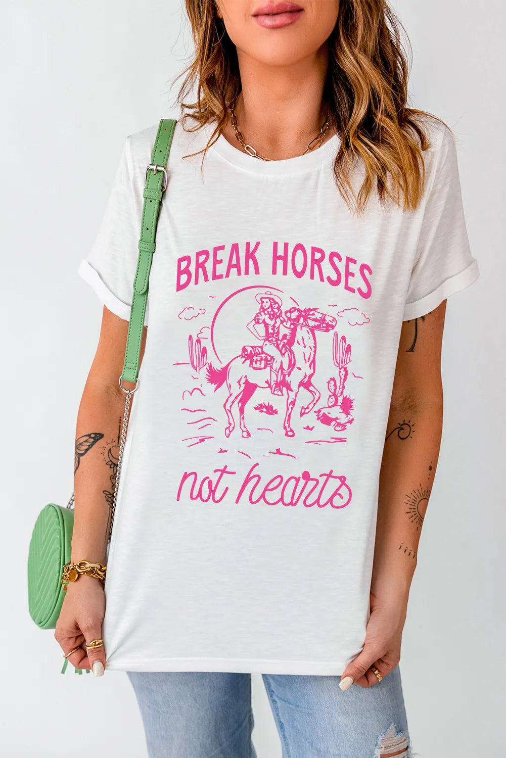 Round neck T-shirt featuring pink cowboy graphic and text.