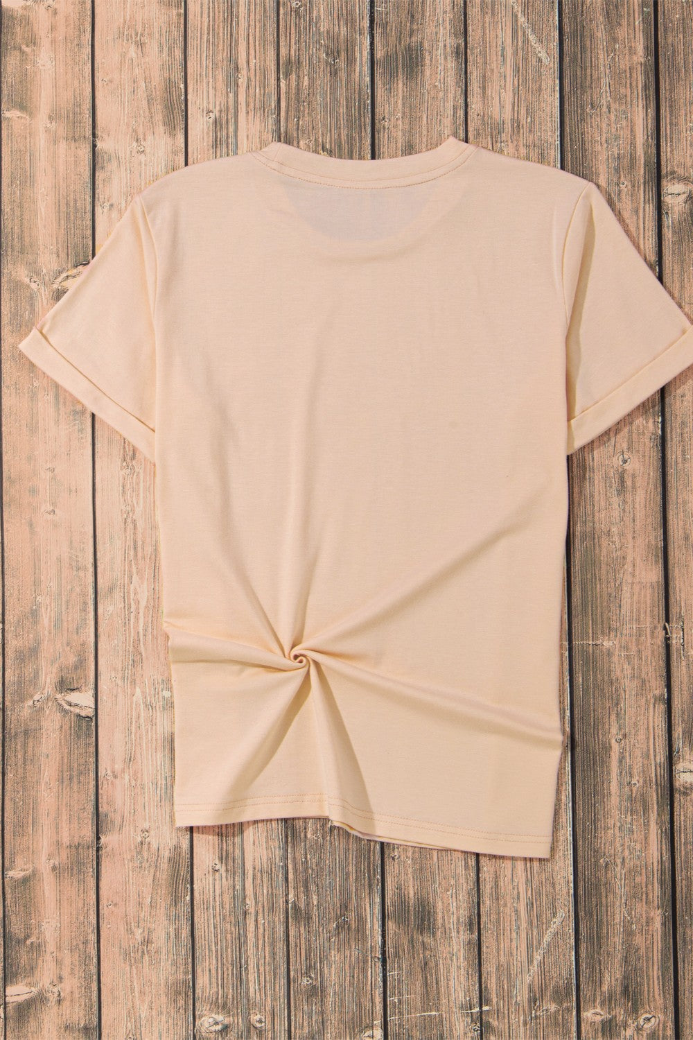 Flat lay of plain short sleeve t-shirt on wooden background
