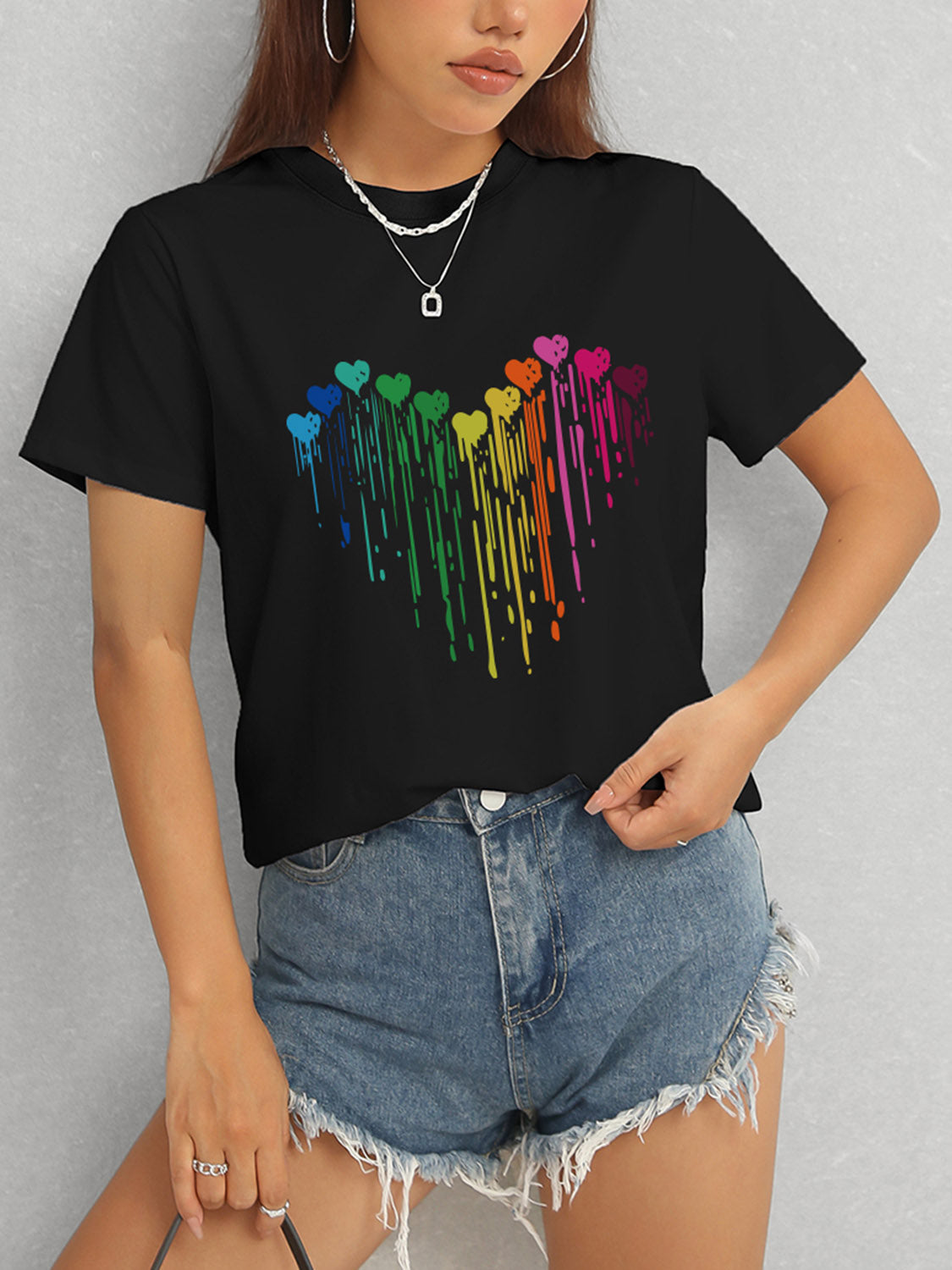 Black t-shirt with rainbow heart design and short sleeves