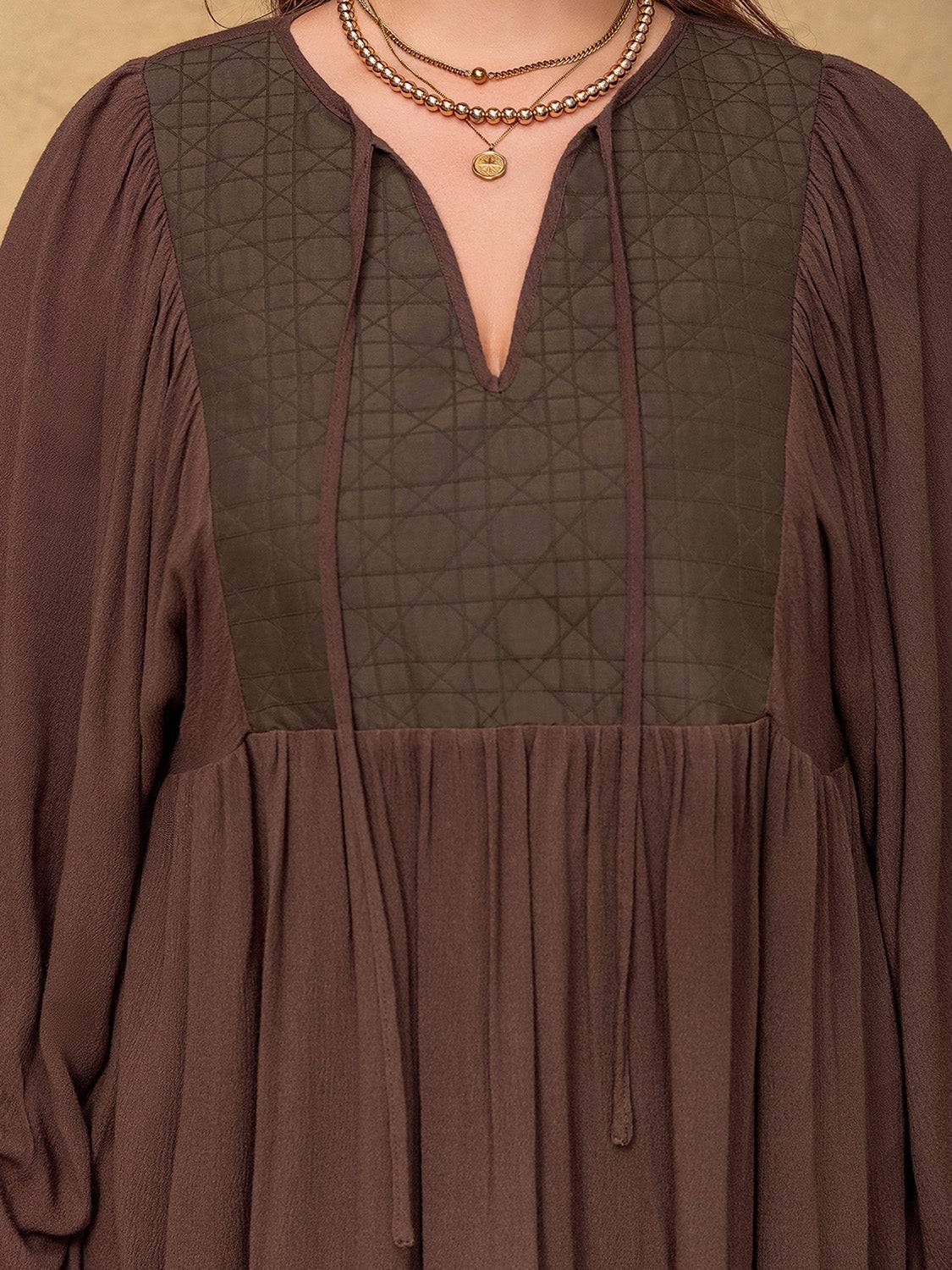 Close-up of tie neck and balloon sleeves on blouse