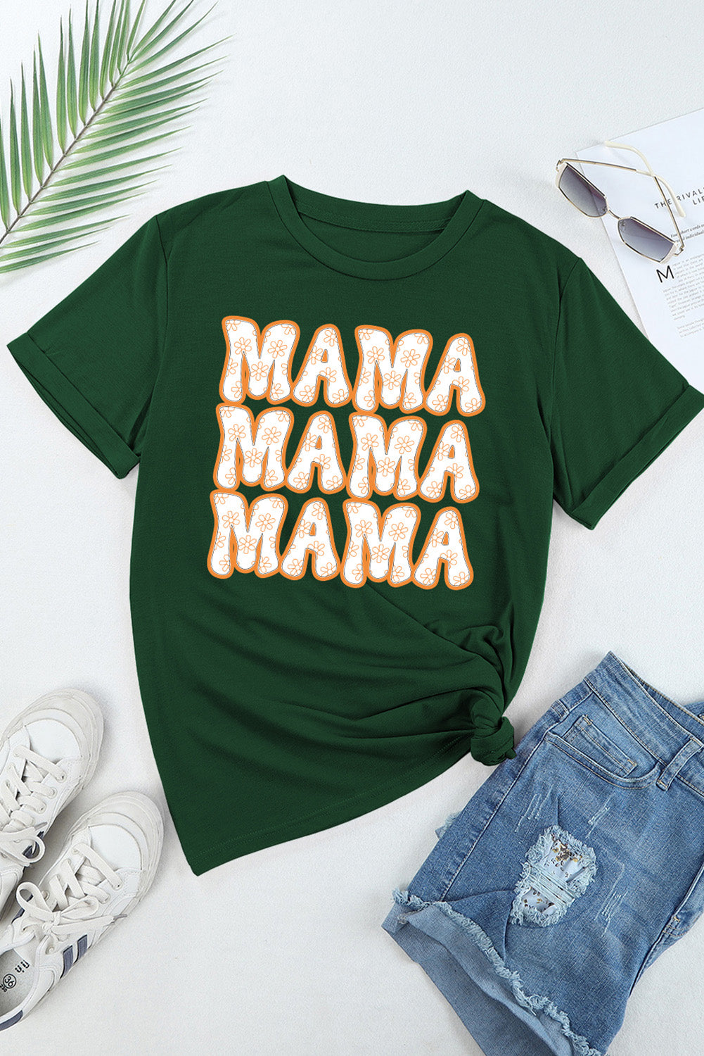 Flat lay of green MAMA T-shirt with jeans and sneakers