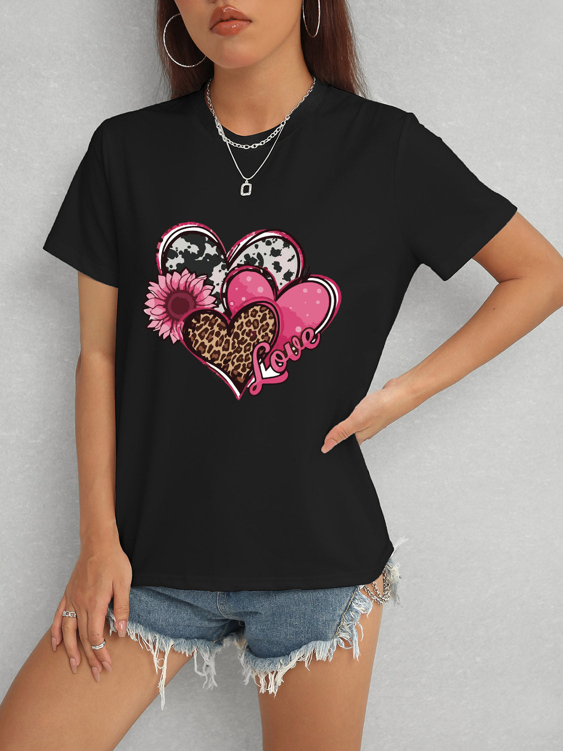 Black short sleeve t-shirt featuring heart and love graphic