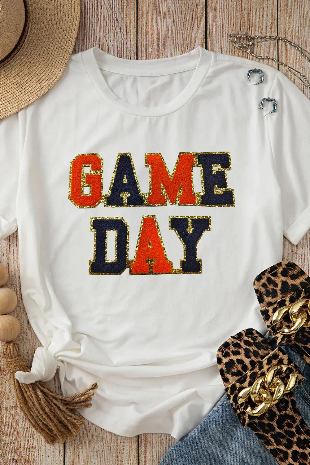 Flat lay of GAME DAY T-shirt with accessories