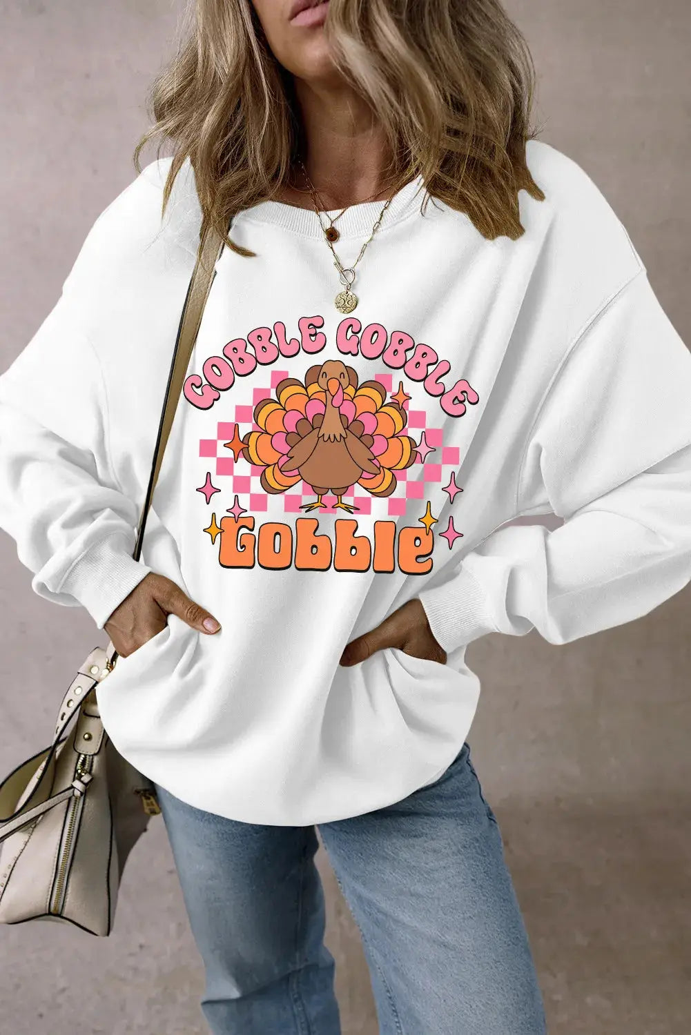 White sweatshirt featuring turkey design and &