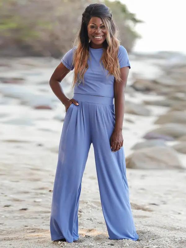 Model in blue two-piece set on beach, front view