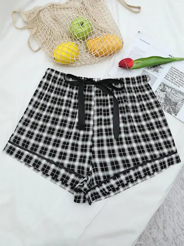 Plaid pajama shorts styled with fruit and magazine
