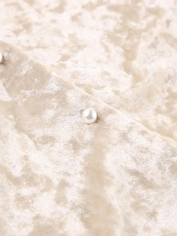 Detail of velvet fabric with pearl accent