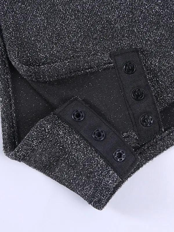 Snap closure detail on black silk bodysuit