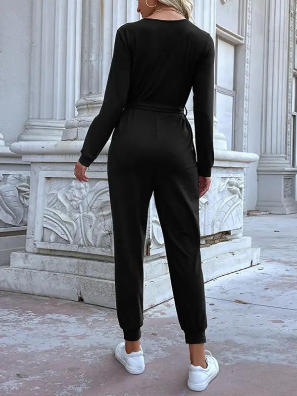 Back view of black hooded jumpsuit with long sleeves