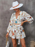White chain print V-neck jumpsuit with long sleeves