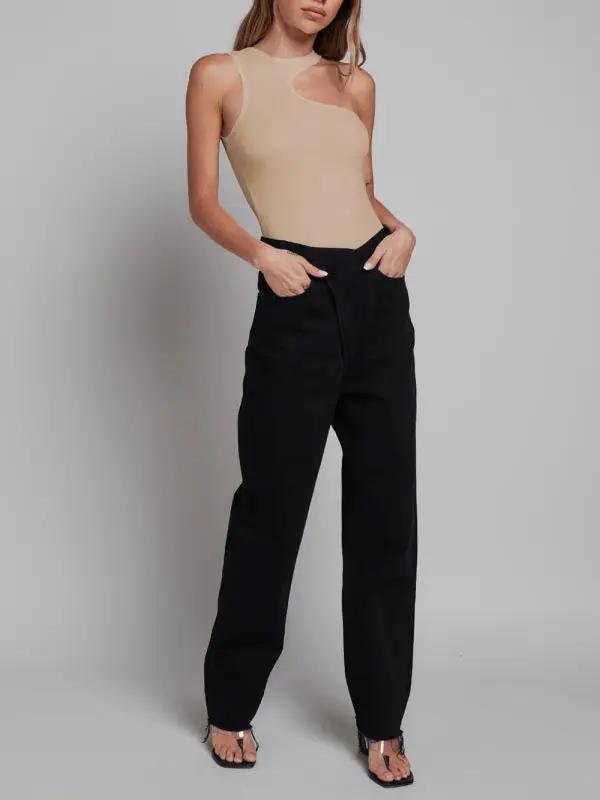 Beige sleeveless jumpsuit paired with black pants