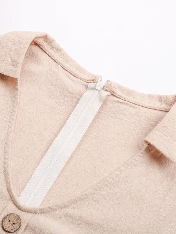 Back view of beige romper with zipper detail