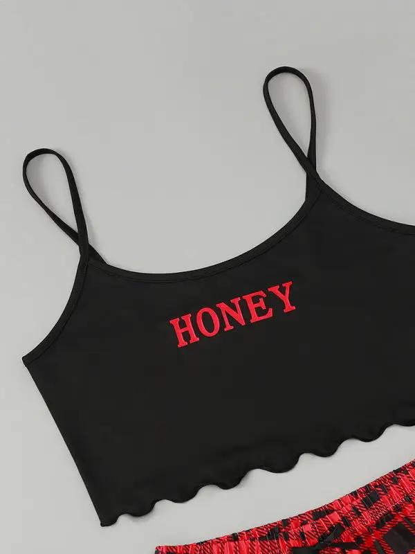 Close-up of black camisole with red &