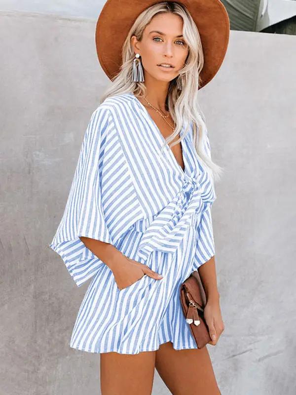 Blue striped jumpsuit with deep V and trumpet sleeves