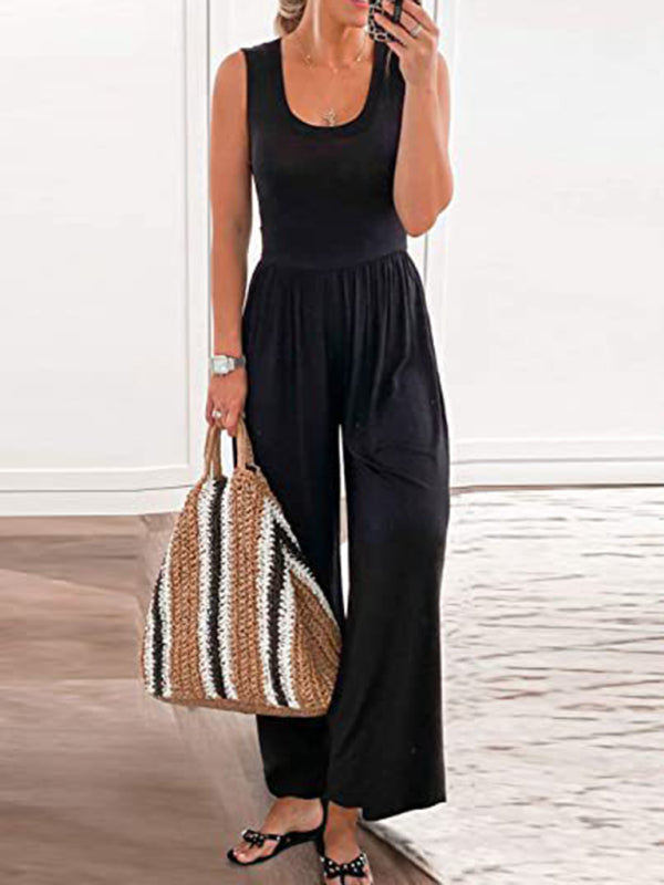 Black sleeveless loose jumpsuit with a woven bag