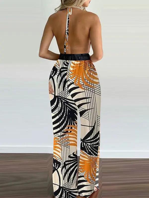 Back view of halter neck jumpsuit with orange and black print