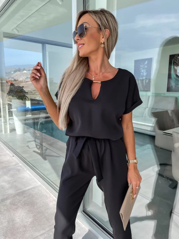 Model in black short-sleeved V-neck cropped jumpsuit