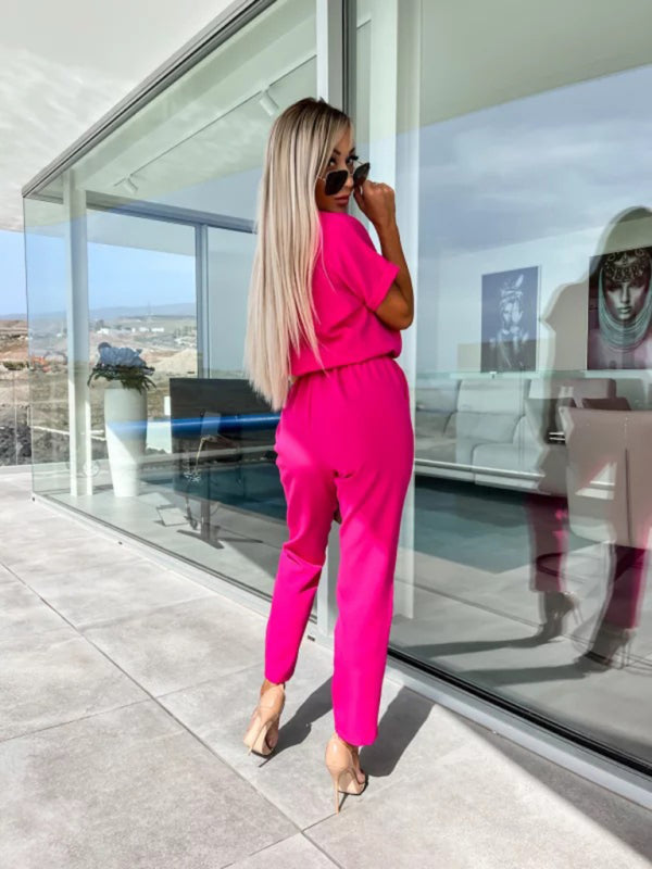 Back view of bright pink elastic waist cropped jumpsuit