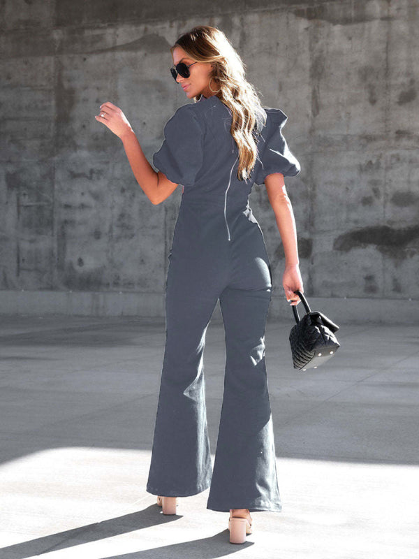 Back view of dark denim jumpsuit with puff sleeves and crossover waist