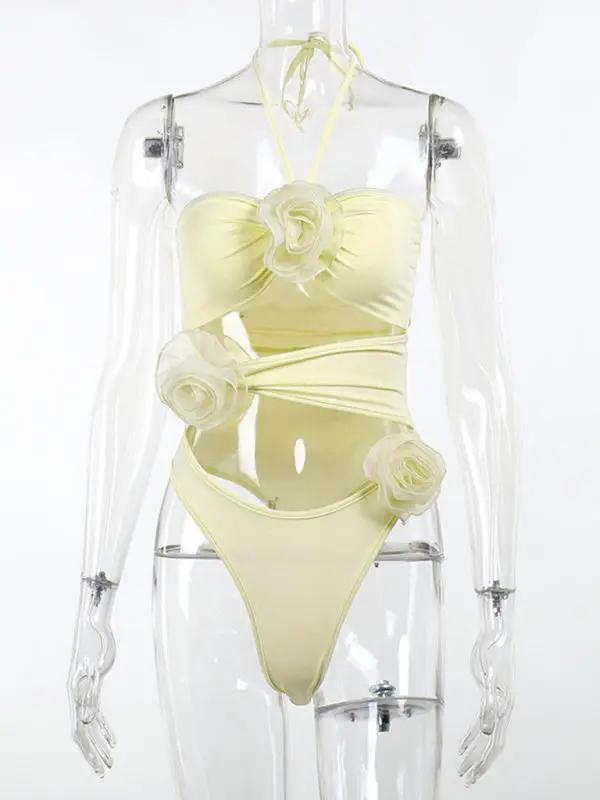 Halter neck jumpsuit with floral accents on mannequin