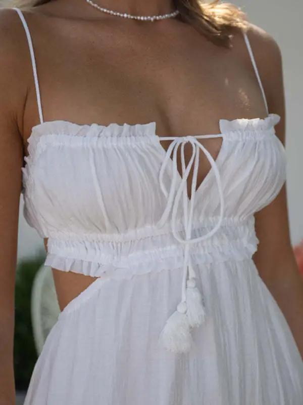Close-up of white dress with tie-front and cutout details