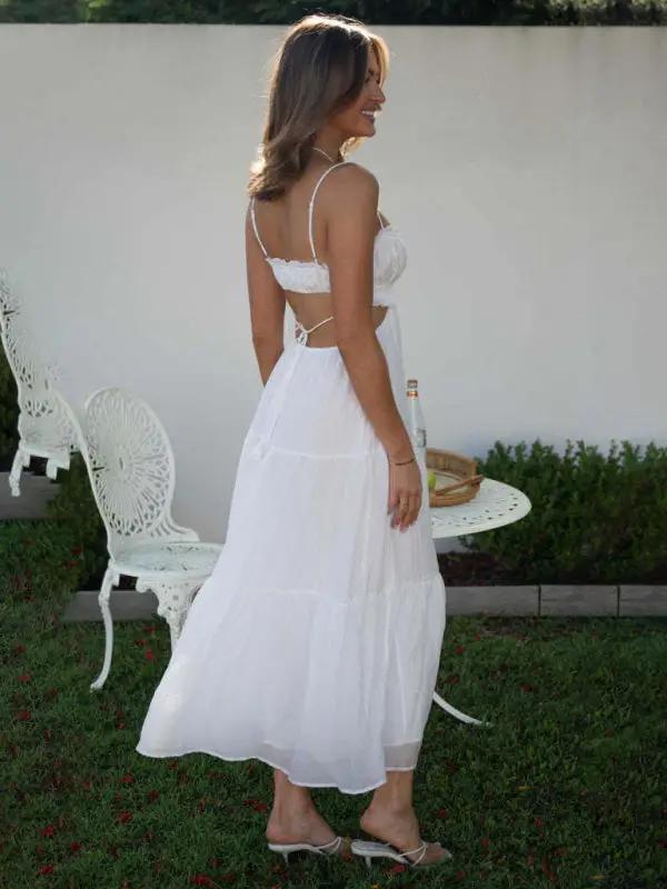 White sleeveless long dress with cutout details, side view