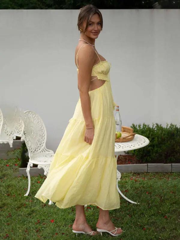 Yellow sleeveless long dress with cutout details, side view
